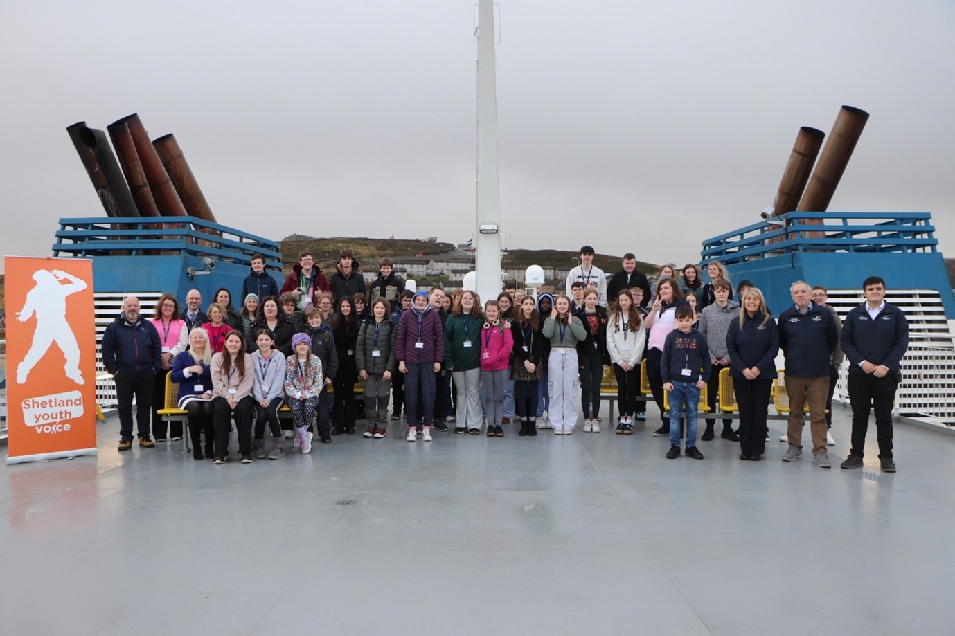 A group of people standing on a boat.