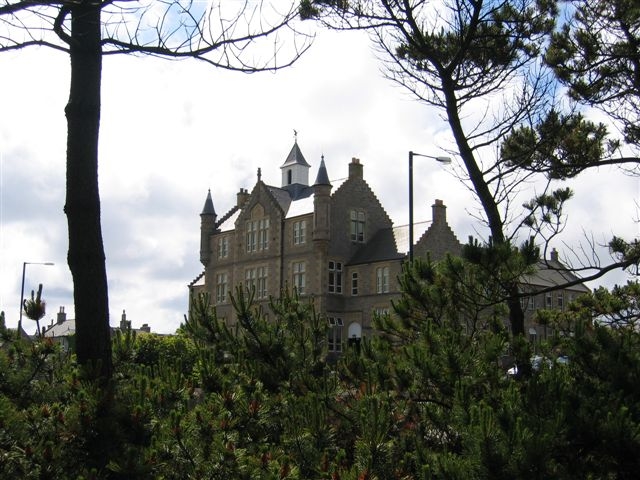 A photo of Islesburgh through some trees.