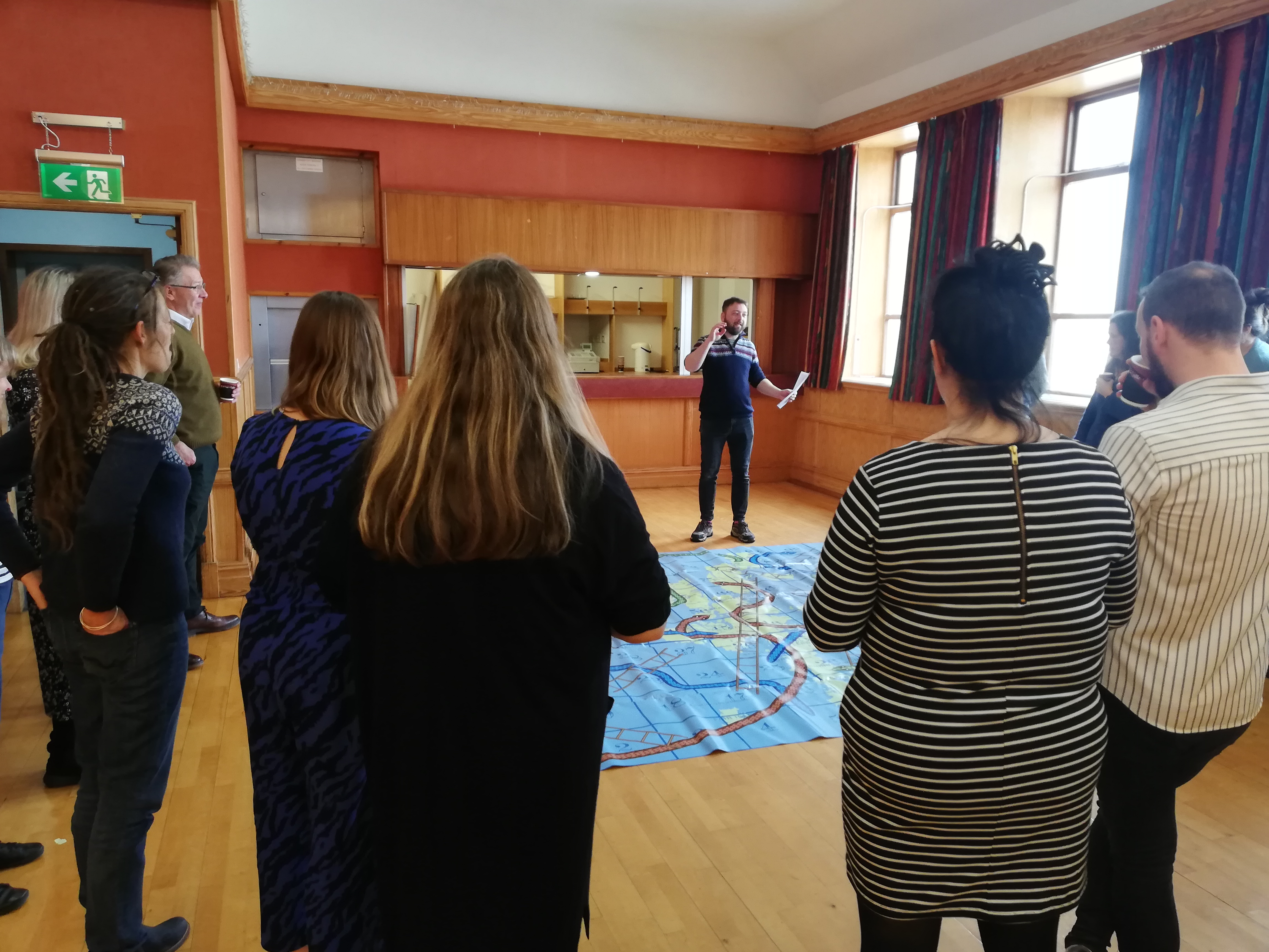 Members of the Network taking part in a giant snakes and ladders game.