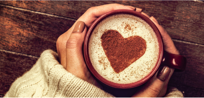 hands holding coffee mug with love heart