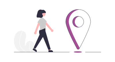 A person walking towards a giant place marker.